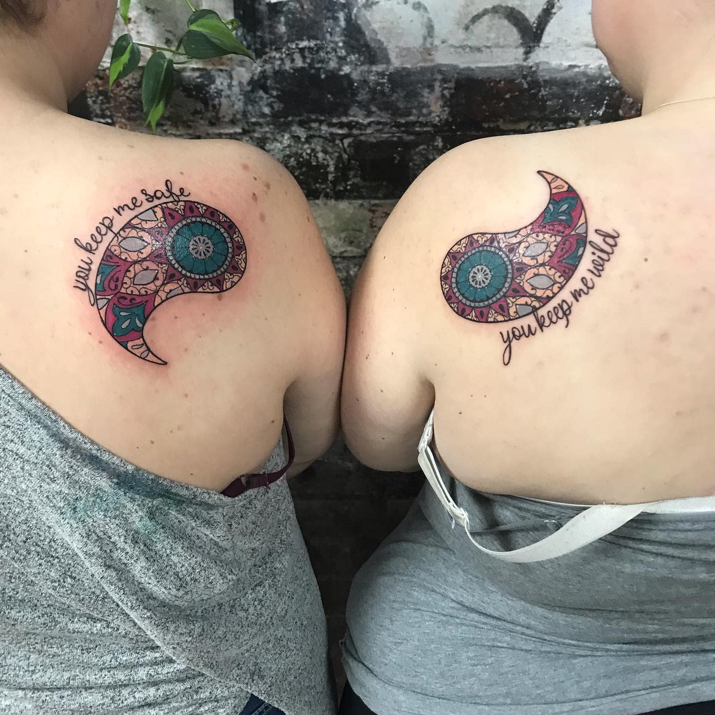 Matching paisley tattoos with intricate patterns and phrases, 'you keep me safe' and 'you keep me wild,' symbolizing balance in a relationship